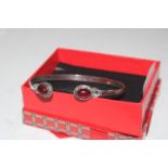 A 925 silver bangle set with red stones
