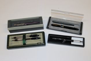A box containing Parker and other pens