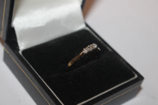 A 9ct gold ring set with three diamonds, size N/O,