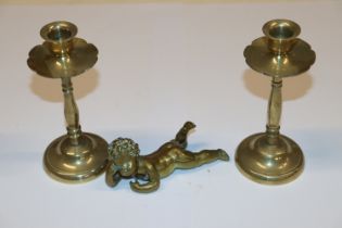 A brass model of a cherub; and a pair of brass can