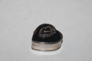 A 925 silver heart shaped pill box with garnet col