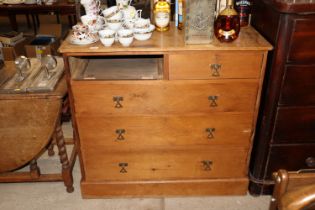 An early 20th Century pine chest lacking one draw
