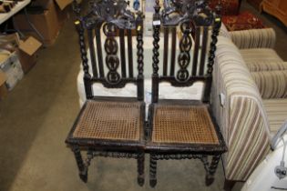 A pair of Victorian carved oak and cane seated hal