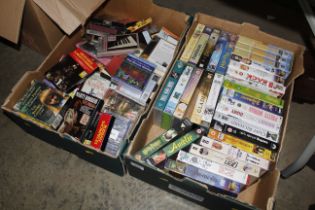 Two boxes of various vintage videos and cassettes