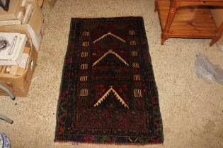 A 130cm x 74cm Baluchi rug