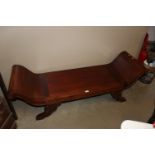 A long carved scroll end bench