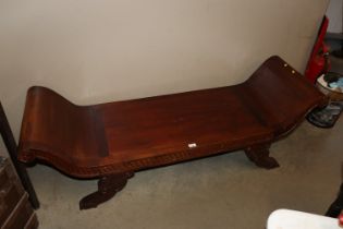 A long carved scroll end bench