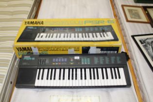 A Yamaha Portatone electronic keyboard and box