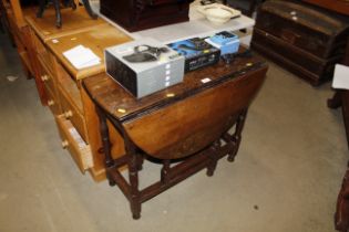An antique gate leg table fitted single drawer