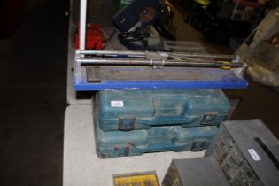 Two Makita tool boxes and a tile cutter