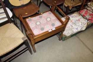 A piano stool with upholstered lifting seat