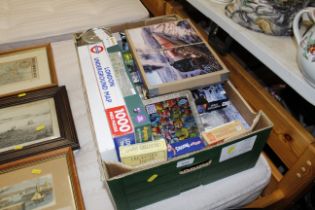 A box of miscellaneous jigsaw puzzles etc.