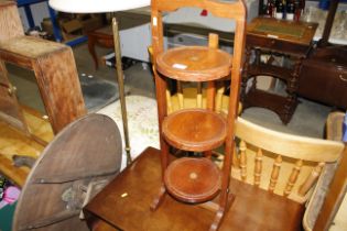 An unusual three tier folding cake stand inset wit