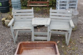 A wooden side by side garden bench