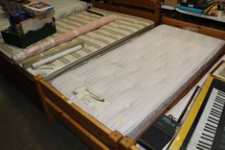 A pine single bed and Dreamworld mattress