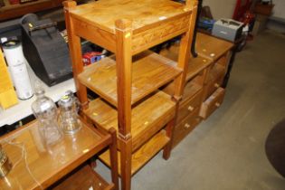 A pair of pine single drawer two tier bedside tabl
