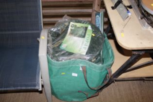 A compost cube and a bag containing pop up garden