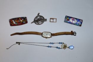 A lady's gold cased wrist watch; silver brooch; en