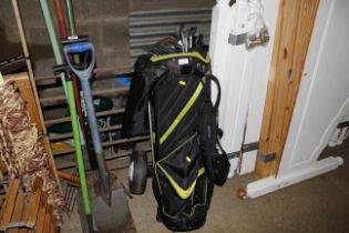 A golf trolley, bag and clubs