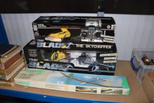 A radio controlled helicopter toy; another and a m