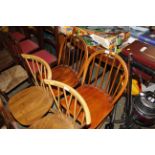 A pair of Ercol stick back kitchen chairs