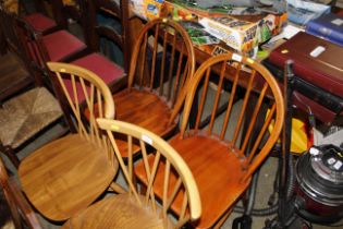 A pair of Ercol stick back kitchen chairs