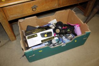 A box of miscellaneous items to include headphones