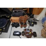 A quantity of various cameras and binoculars inclu