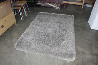 An approx. 6'6" x 4'8" shag pile rug