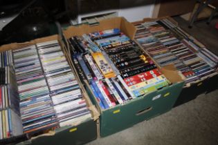 Three boxes containing various videos and CDs