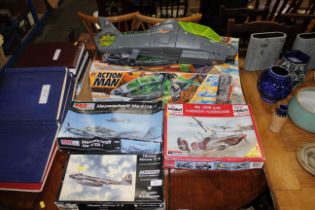 Three model aeroplane kits and an Action Man helic