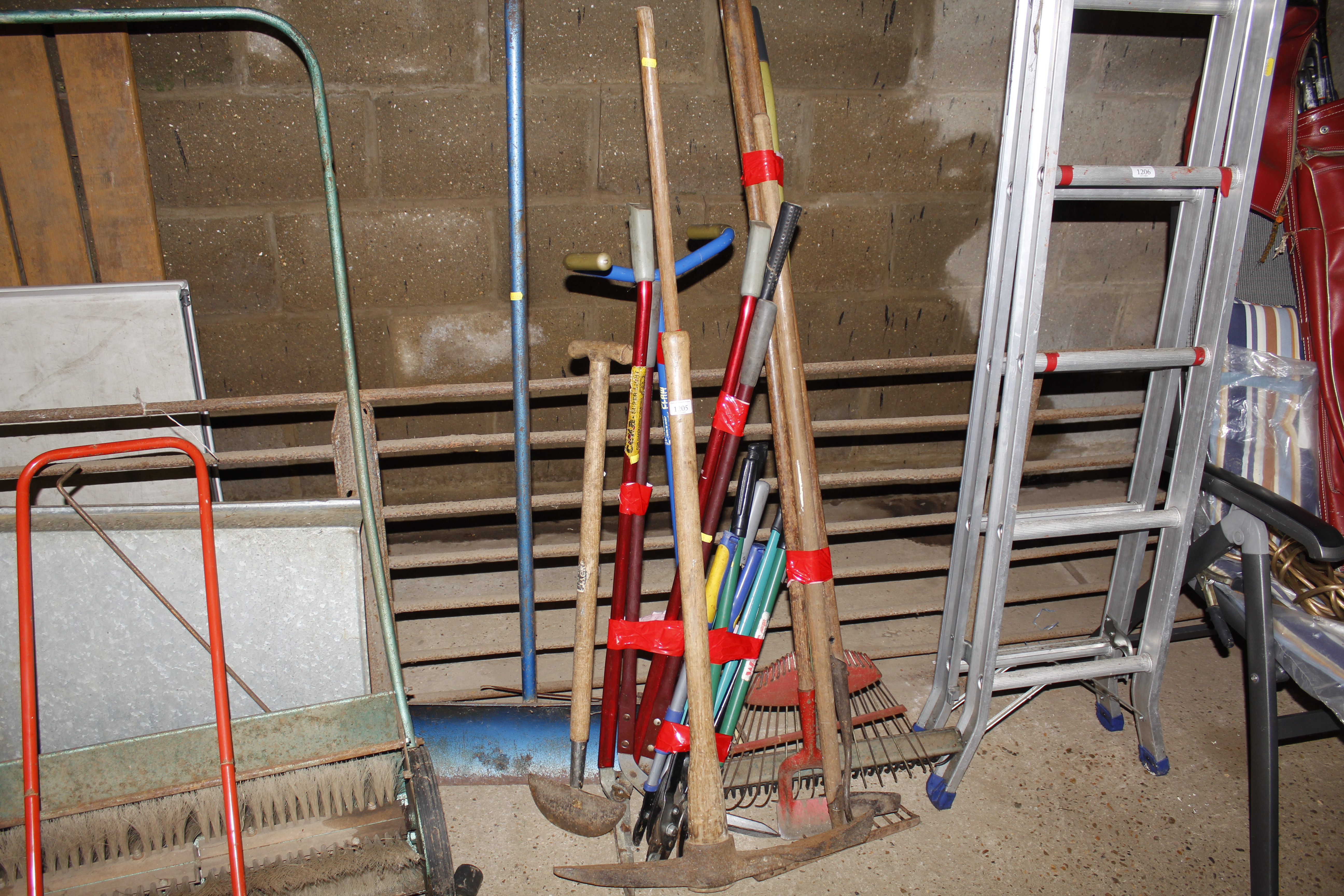 A collection of long handled garden tools to inclu