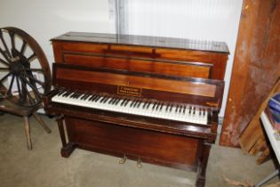An F Sebastian upright piano, retailed by Waring a