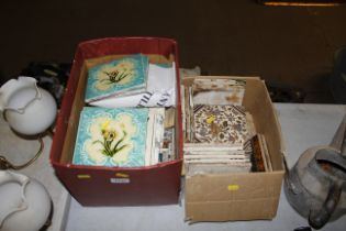 Two boxes of decorative tiles
