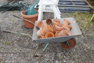 A galvanised wheelbarrow and a collection of flowe