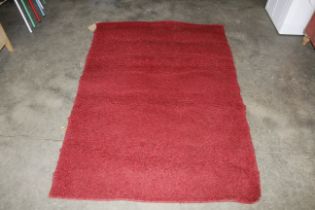 An approx. 5'5" x 3'9" red wall rug