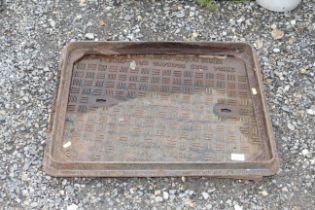 A cast iron man hole cover with frame