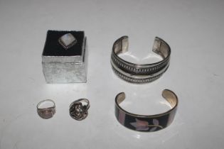 Two white metal bangles; a 925 silver ring with st