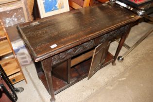 A carved oak side cabinet, with carved frieze and