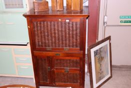 An Oriental cane front desk with drawers and cupbo