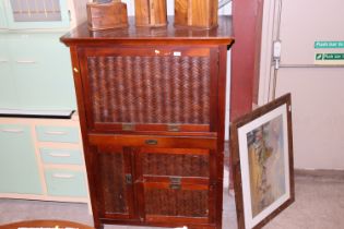 An Oriental cane front desk with drawers and cupbo