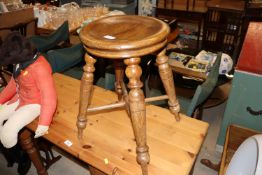 An elm cheese stool on tapering supports