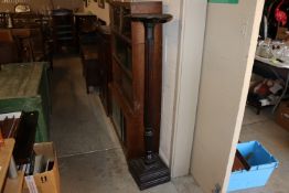 A mahogany torchere stand on fluted column