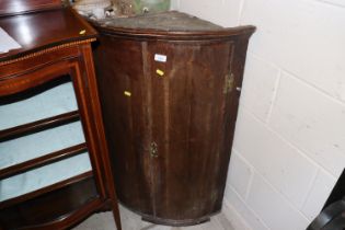 An antique oak and cross banded elliptical corner