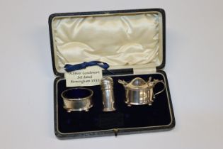 A cased Birmingham silver three piece cruet set