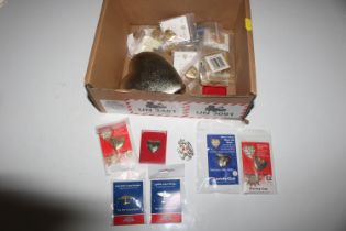 A box of various charity badges