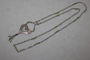 A 38" Sterling silver peridot and mother of pearl