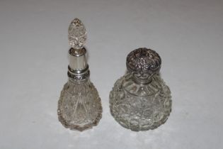 A Globular glass silver lidded perfume bottle and