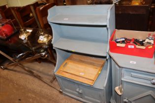 A painted graduated bookcase with cupboard base