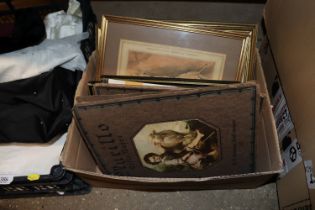 A box containing various pictures and prints etc.